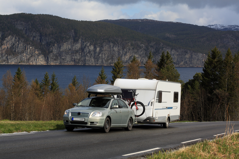 car pulling caravan by the mountains